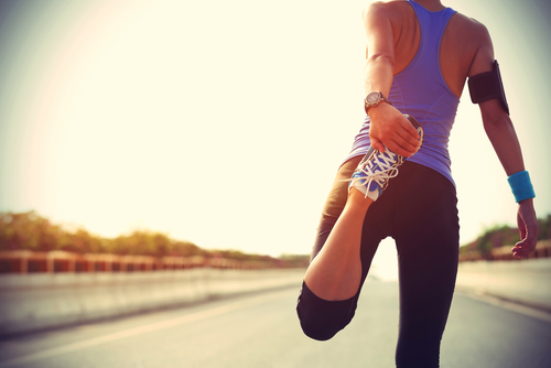 Young,Fitness,Woman,Runner,Stretching,Legs,Before,Run,On,City running injury clonee physio